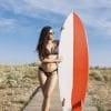 Beautiful young lady with surfboard