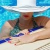 very pretty woman wearing hat in pool