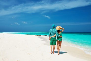 Couple arm in arm on beach