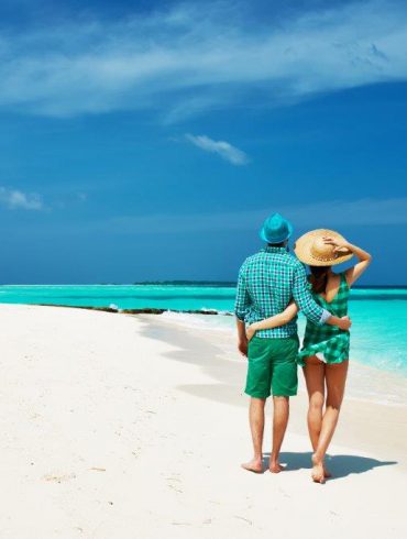 Couple arm in arm on beach