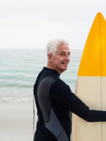 older guy with surfboard
