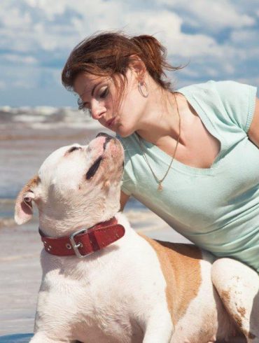 woman and dog on beach