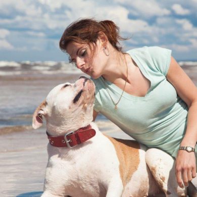 woman and dog on beach