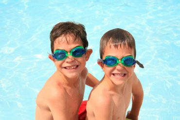 young boys in water wearing goggles