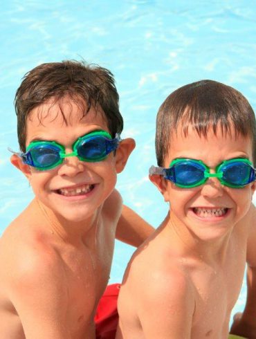 young boys in water wearing goggles