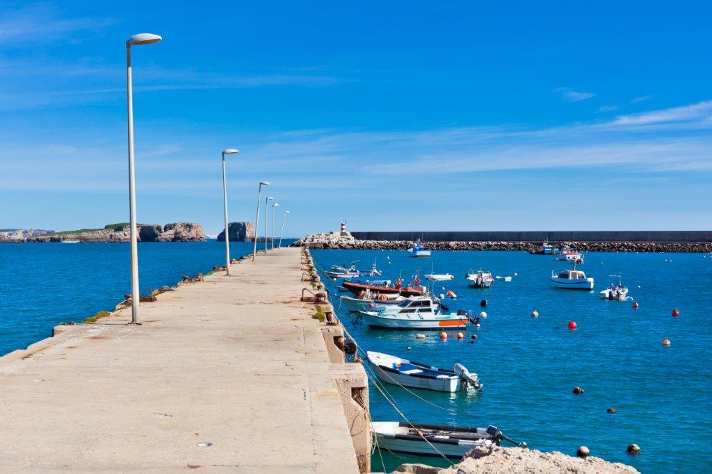 Old pier with boats at Sagres Portugal