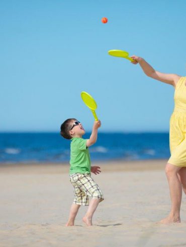 A mother and son playing on the beach