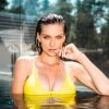 Beautiful woman in yellow bikini in swimming pool