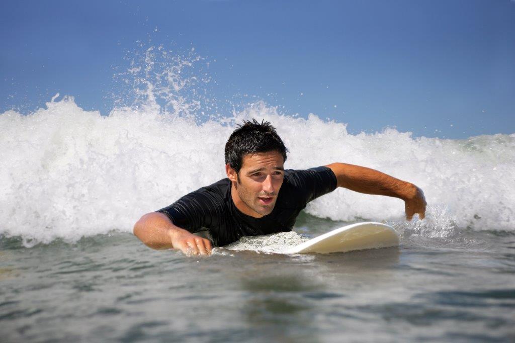 surfer paddling through water