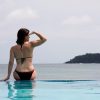 woman in pool by ocean