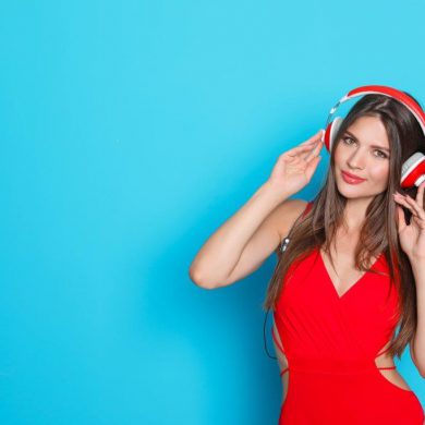 woman wearing headphones on a light blue background