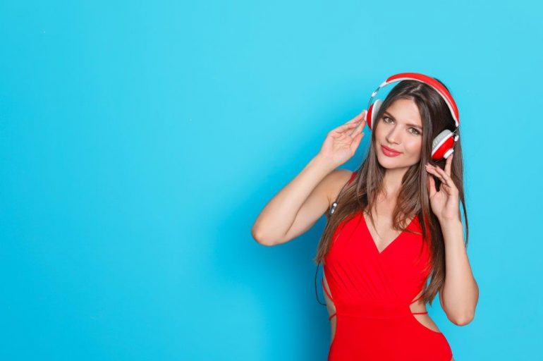 woman wearing headphones on a light blue background