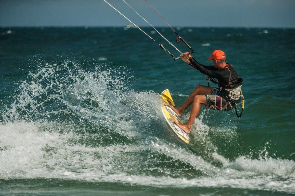 Man Kitesurfing in blue sea