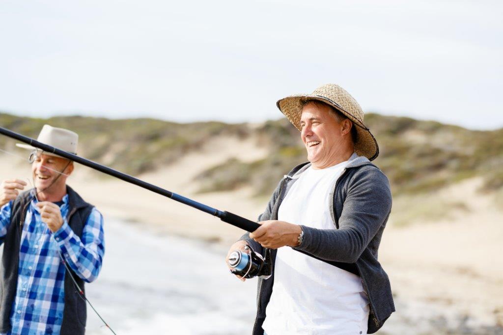 Two old buddies fishing at the coast