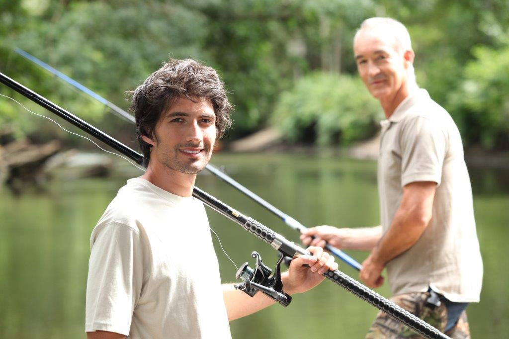 Older son fishing with father