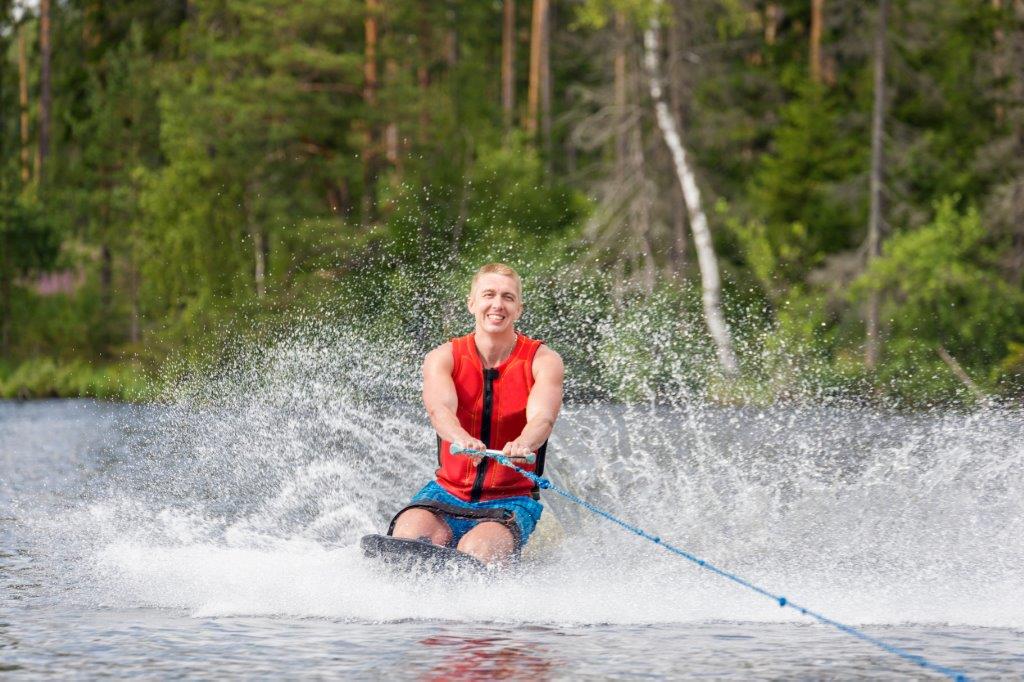 man riding kneeboard on a lake