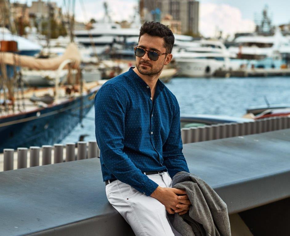 Handsome man on dock illustrating nautical fashion men