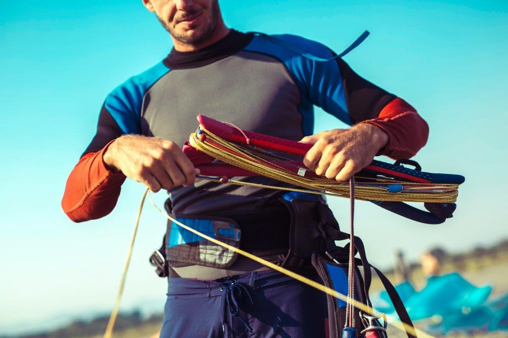 Surfer in wetsuit with kite equipment