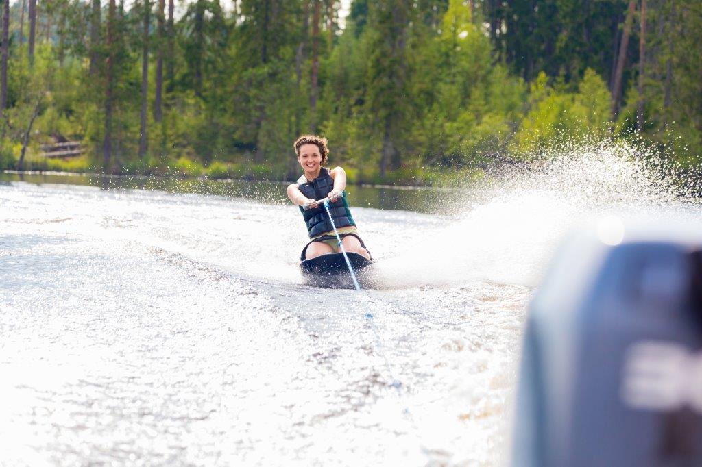 woman riding kneeboard on a lake