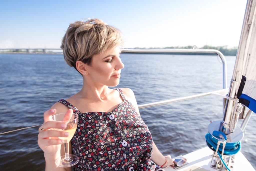 Woman drinking wine on a yacht